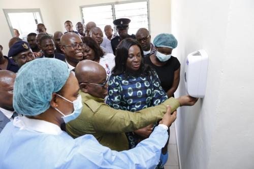 President Nana Addo Dankwa Akufo-Addo being assisted by staff of Ridge Hospital to use a sanitizer after the tour of the facility.