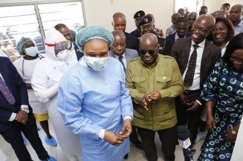 President Nana Addo Dankwa Akufo-Addo being assisted by staff of Ridge Hospital to sanitize after his hands after the tour of the facility.